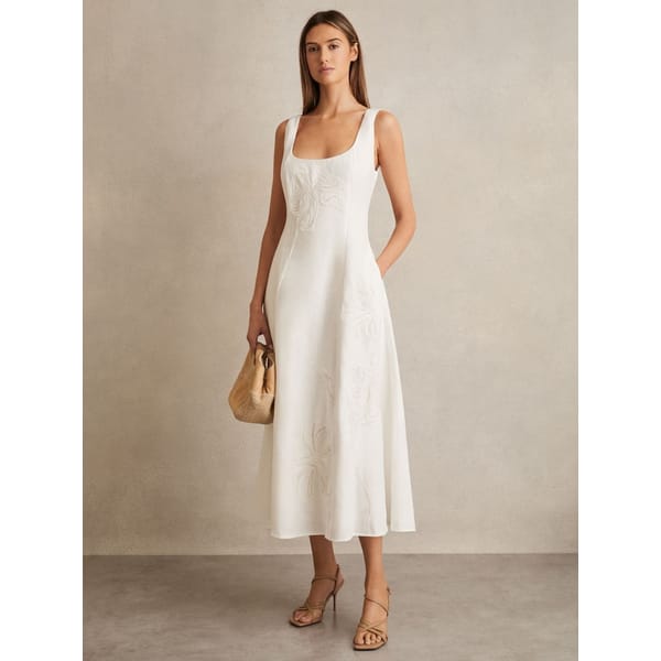 model wearing Elise Linen Floral-Embroidered Midi Dress in Ivory