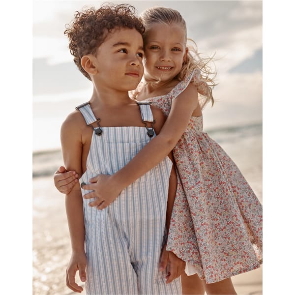boy and girl wearing the white company clothes on the beach