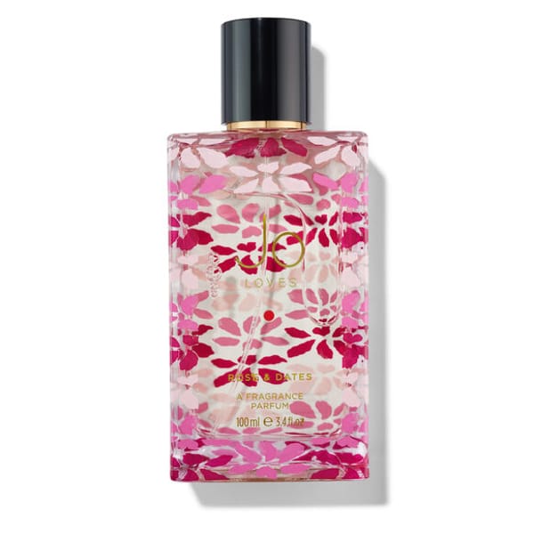 A rectangular glass perfume bottle with a black cap, featuring a pink and white floral design. Gold text reads JO LOVES, PINK VETIVER, and A FRAGRANCE PARFUM 100ml e 3.4 fl oz—perfect for those who adore romantic scents and love perfumes.