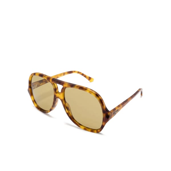 A pair of Chloé Eyewear Salomé oversized, oval-shaped sunglasses with brown-tinted lenses and a yellow-brown tortoiseshell patterned frame, displayed on a white background.