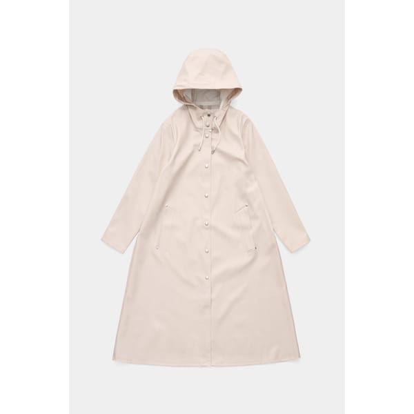 Cream-coloured hooded raincoat with long sleeves, front press studs, two slanted front pockets, and a drawstring at the hood—one of our stylish waterproof jackets—laid flat on a white background.