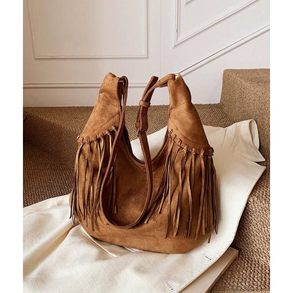 brown suede fringed bag on stairs