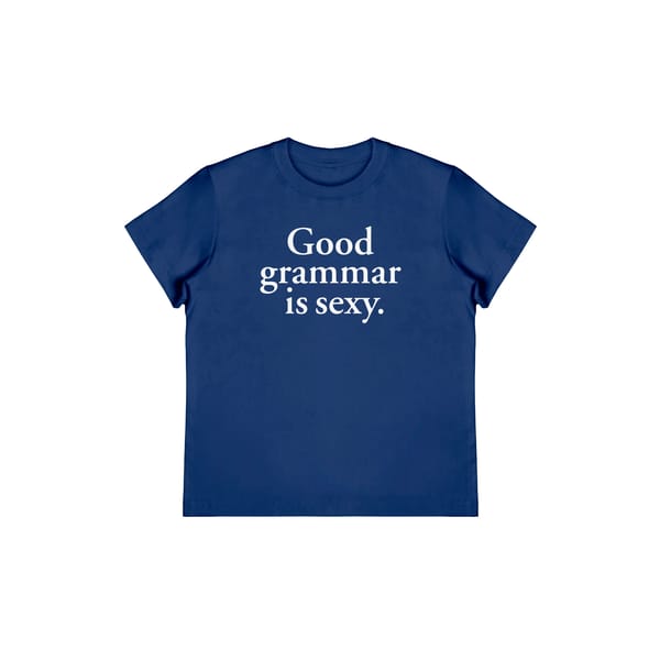 A blue T-shirt with the text Good grammar is sexy. printed in white letters on the front—perfect for fans of trending slogan tees.
