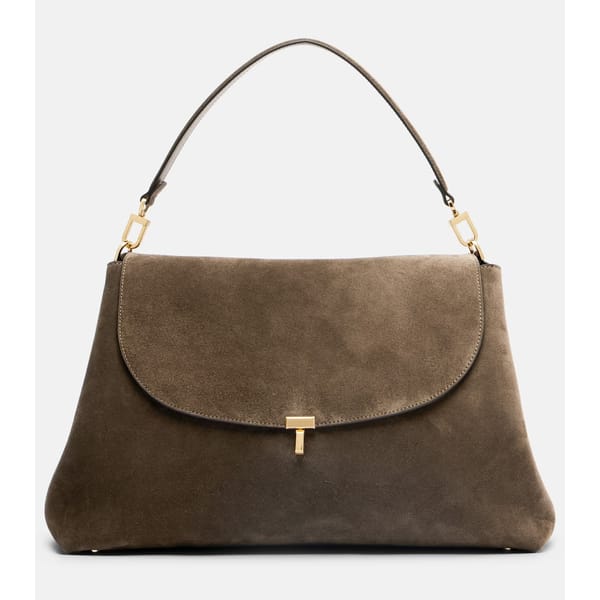 A taupe suede handbag with a curved flap, gold clasp fastening, and a single top handle. The bag has a minimalist, elegant design with gold hardware accents—perfect for elevating any outfit during our exclusive summer sale.