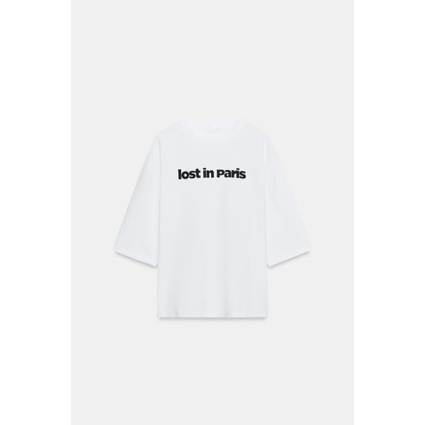 A plain white T-shirt with the phrase lost in Paris printed in bold black letters across the chest, displayed on a white background—perfect for fans of cool slogan tops.