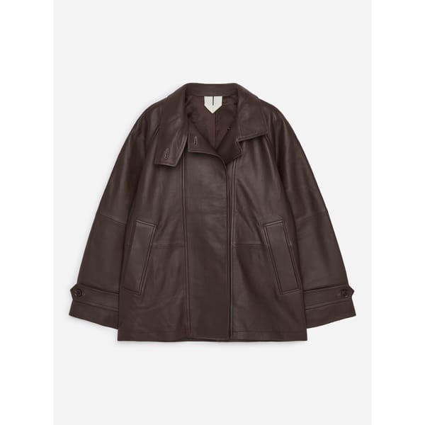 Dark brown leather jacket with a notched collar, two side pockets, and button-tab cuffs, representing some of the best women’s leather jackets.
