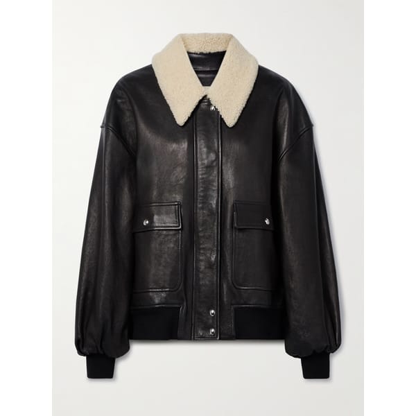 Black leather jacket with a cream-coloured sheepskin collar, two front pockets, and ribbed cuffs; one of the best women’s leather jackets for a classic look.