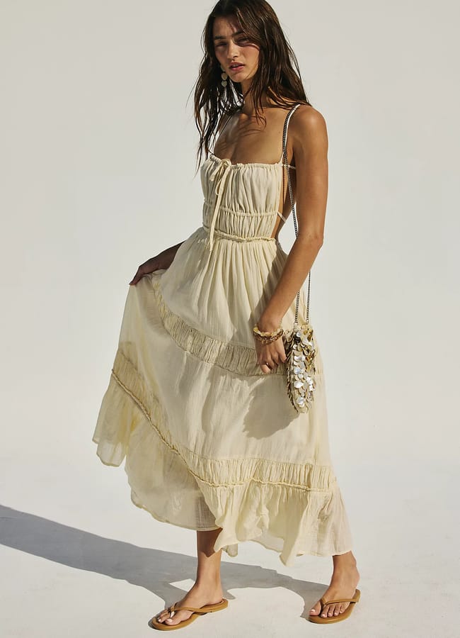 model wears pale yellow ruched corset dress