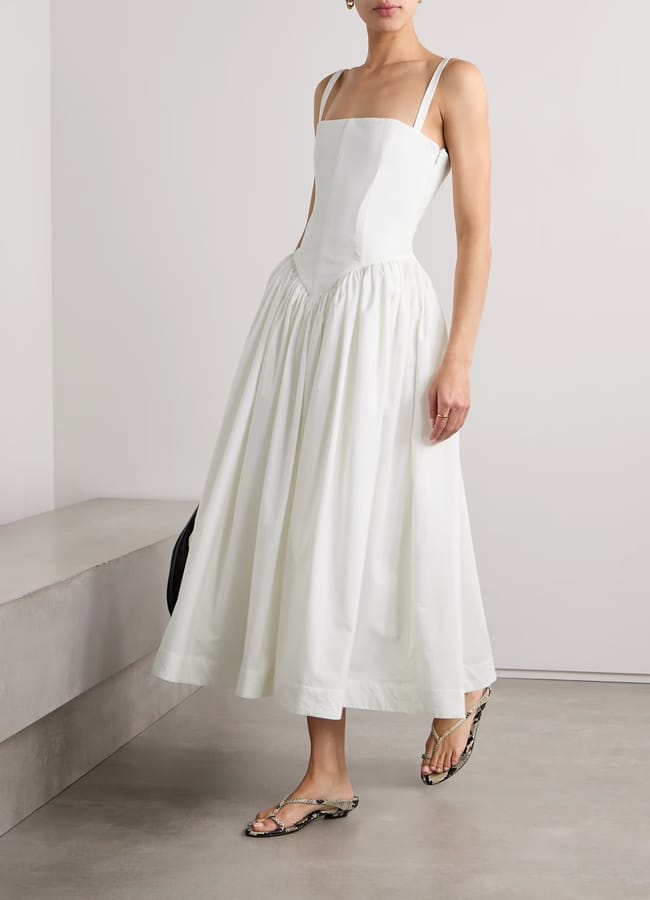 model wears white midi dress with corset detail