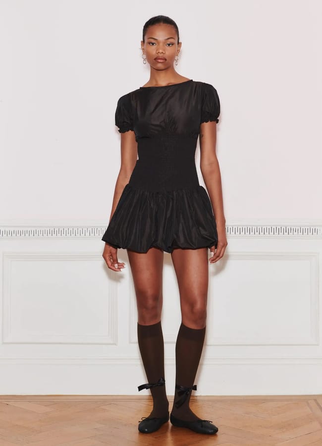 model wearing black corset style dress