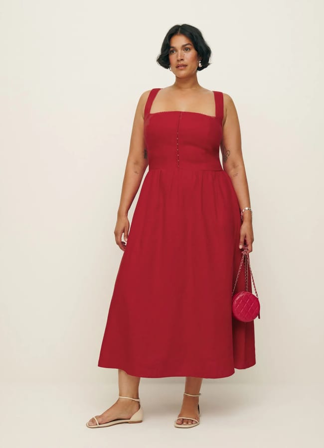 model wears red corset midid dress