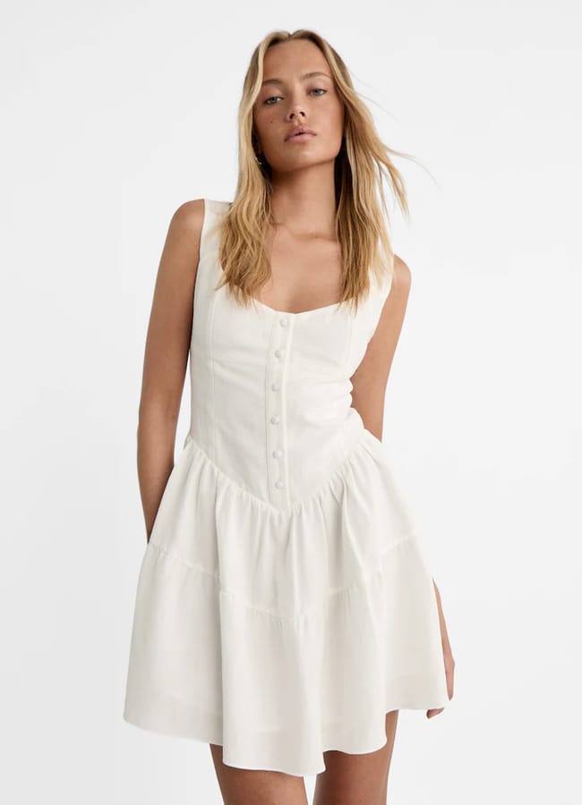 model wears white corset dress