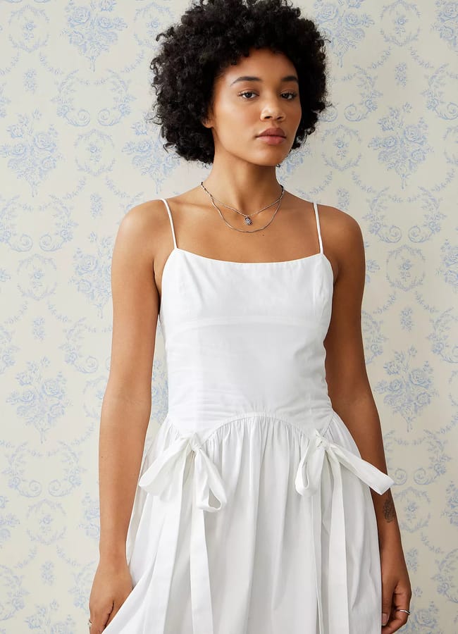 model wears white dress