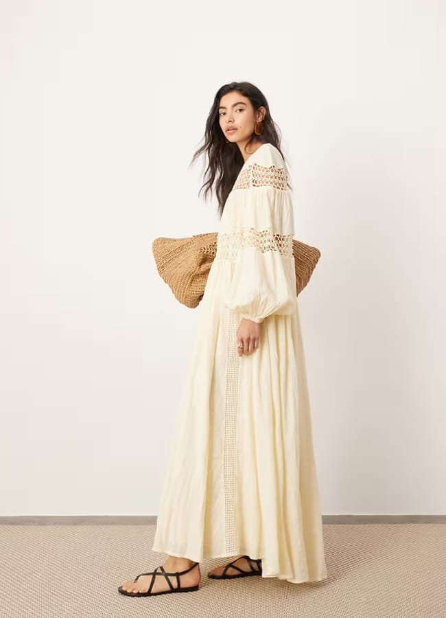 model wearing ASOS EDITION crochet trim drop waist blouson sleeve trapeze maxi dress in buttermilk