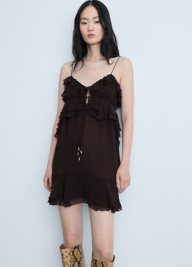 Model wearing black ruffle cami dress