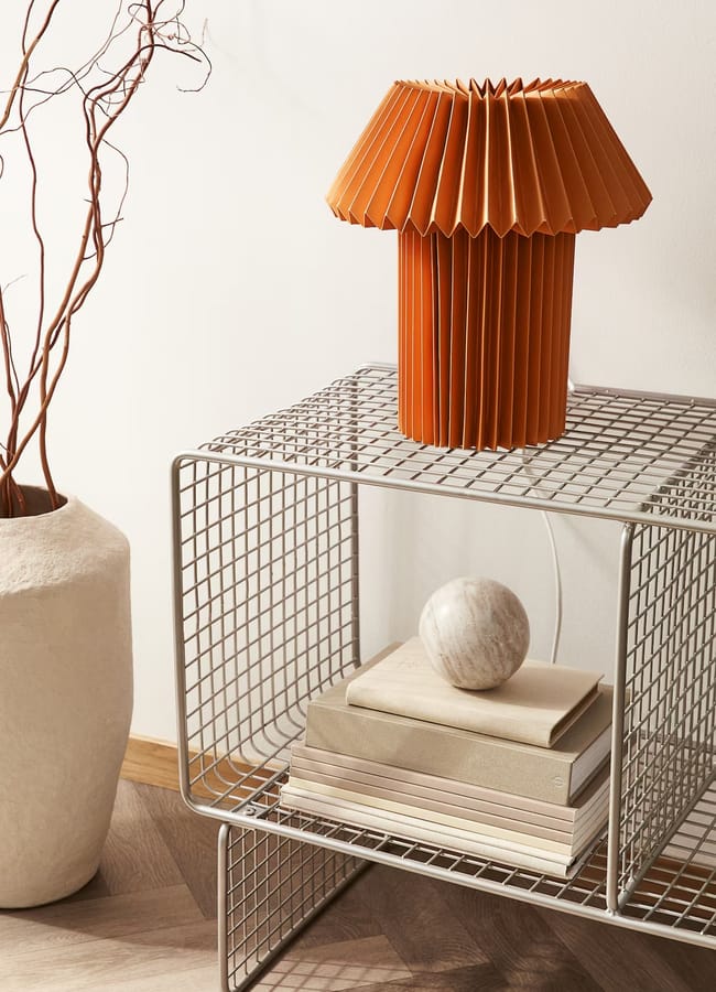 pleated red lamp on side table