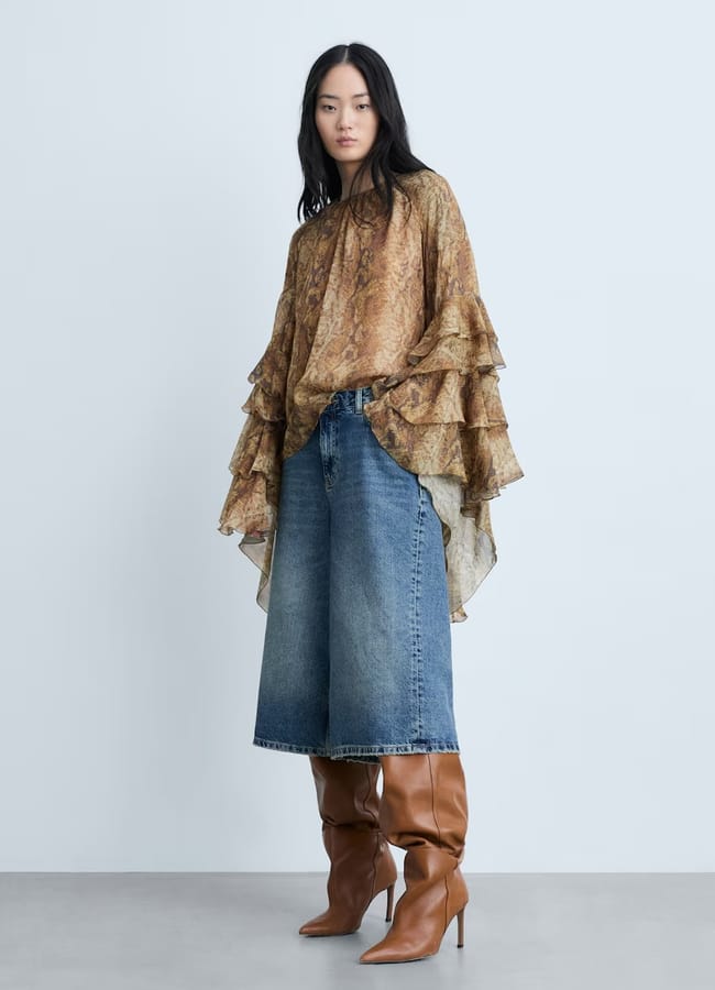 model wearing Ruffle blouse with snake print