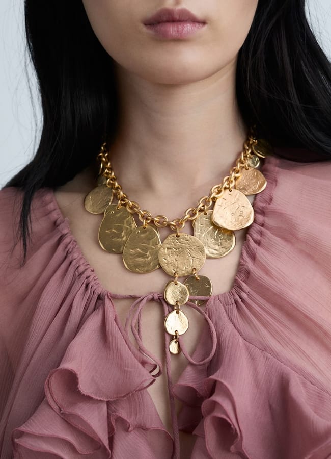 close up of model wearing MANgO Coin waterfall necklace