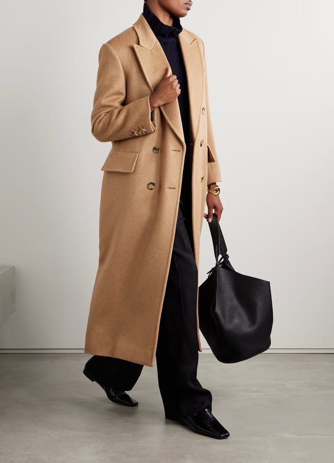model wears camel coat