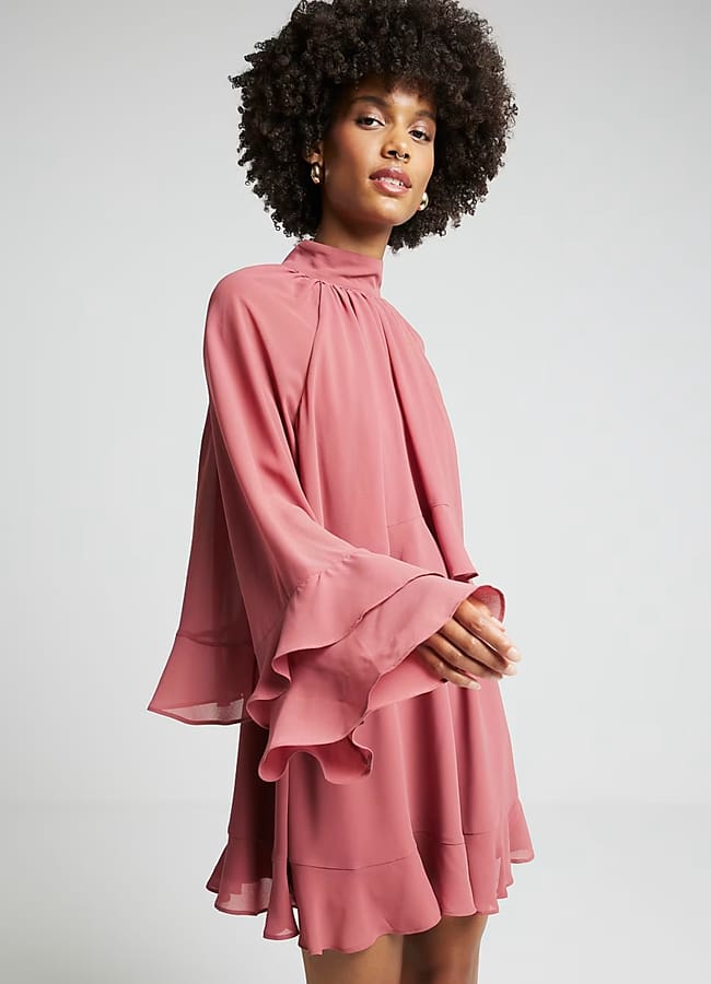 model wearing river island Pink layered ruffle smock mini dress