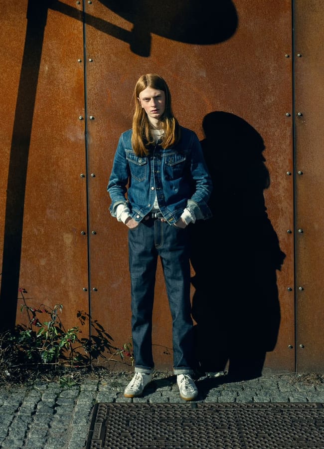 model in front of wall wearing Steady Eddie II Gravity Selvage nudie jeans