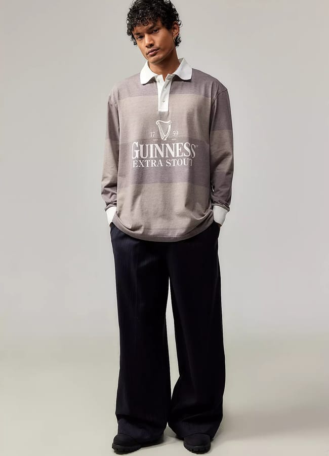 male model wearing UO Basic Pleasure Mode Guinness Stripe Rugby Shirt