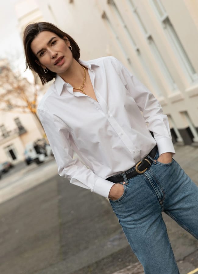 model in street in jeans and white shirt