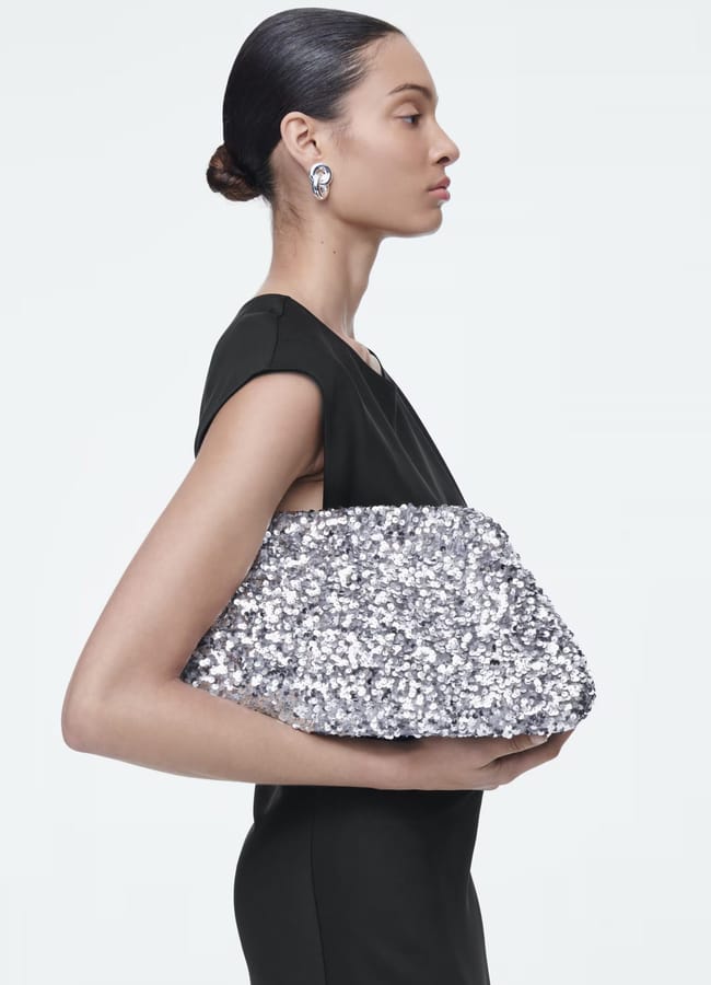 model holding sequin silver bag