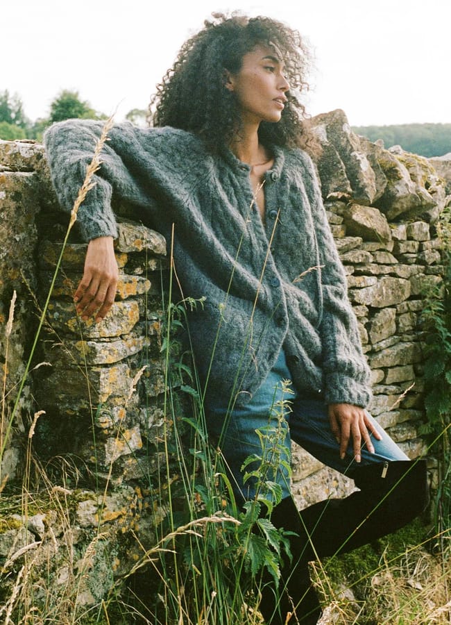 model in field wearing grey cardigan