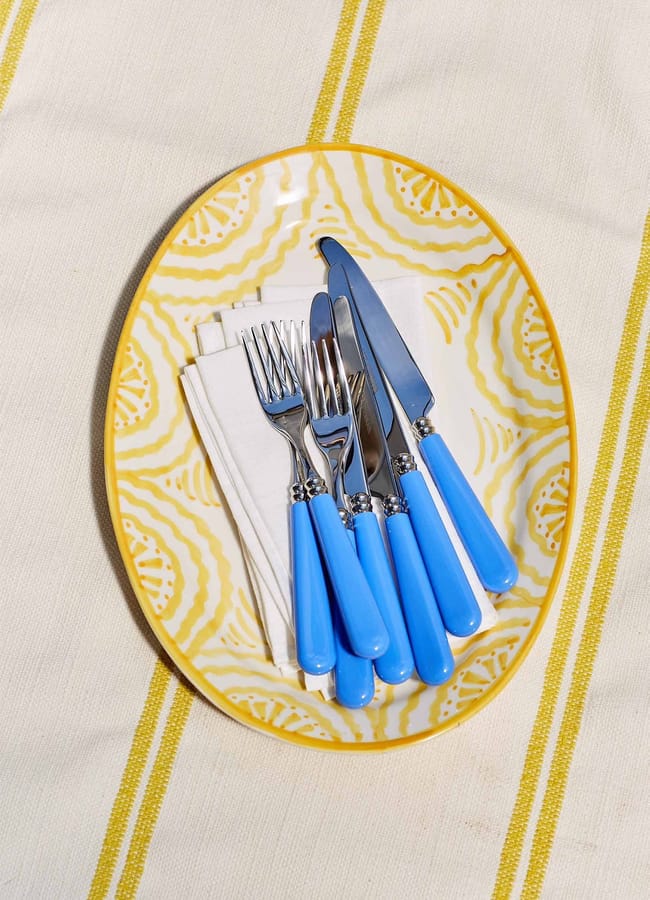 blue cutlery on yellow plate dish
