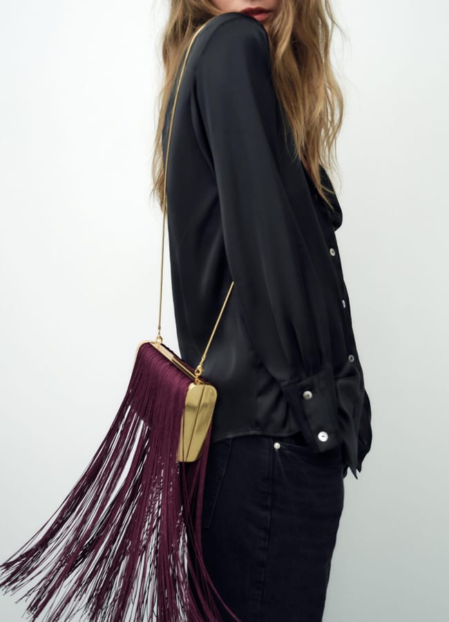 model wearing fringed bag