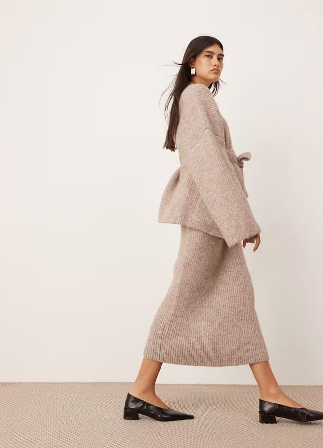 model wearing ASOS EDITION ribbed knitted maxi skirt and chunky knit wrap longline cardigan co-ord in taupe
