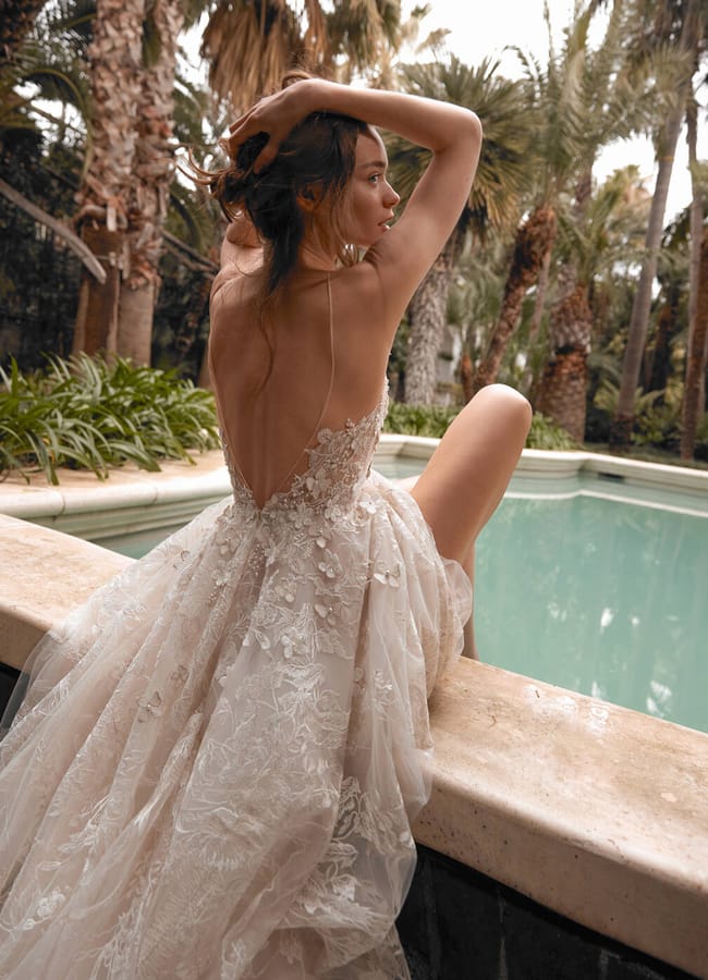 model by pool in wedding gown