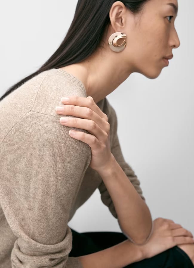 model sitting to the side wearing Pure Cashmere V-Neck Jumper