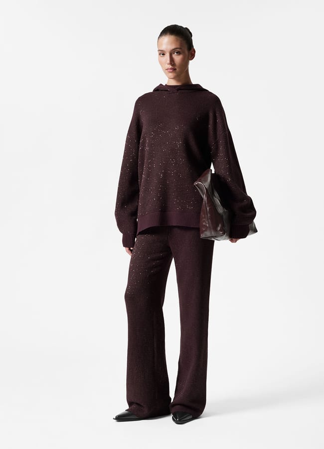 model wearing brown metallic hoodie and trousers
