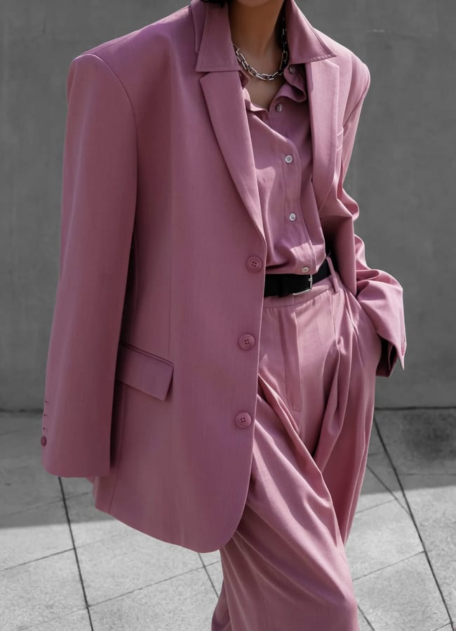 close up of model wearing pink suit