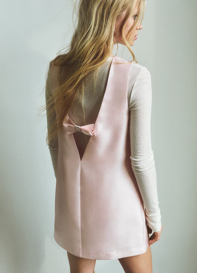 model from back in pink bow dress