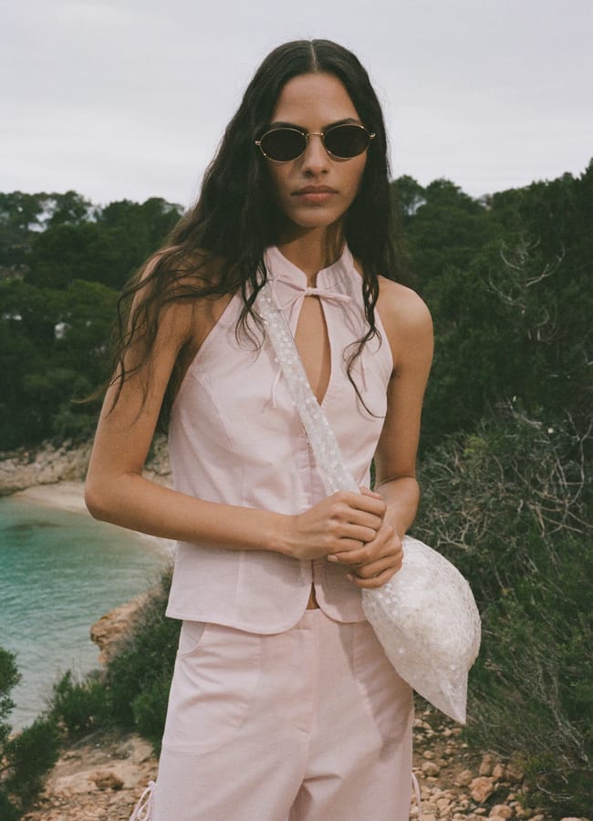 model by coast wearing MANGO Halter top with bow opening in pink