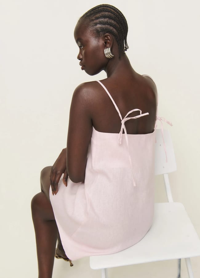 model from back wearing THE REFORMATION Aubree Linen Dress in pink