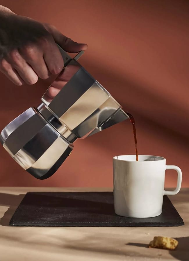 hand pouring liberty 6 Cup Moka Espresso Coffee Maker