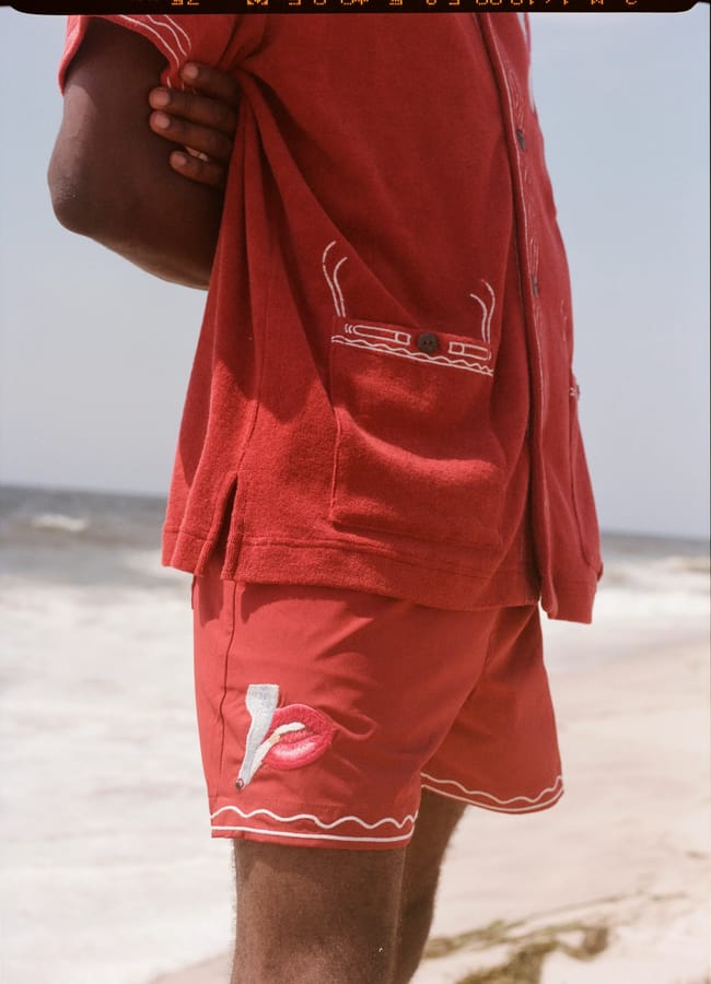 close up of red swim shorts on beach