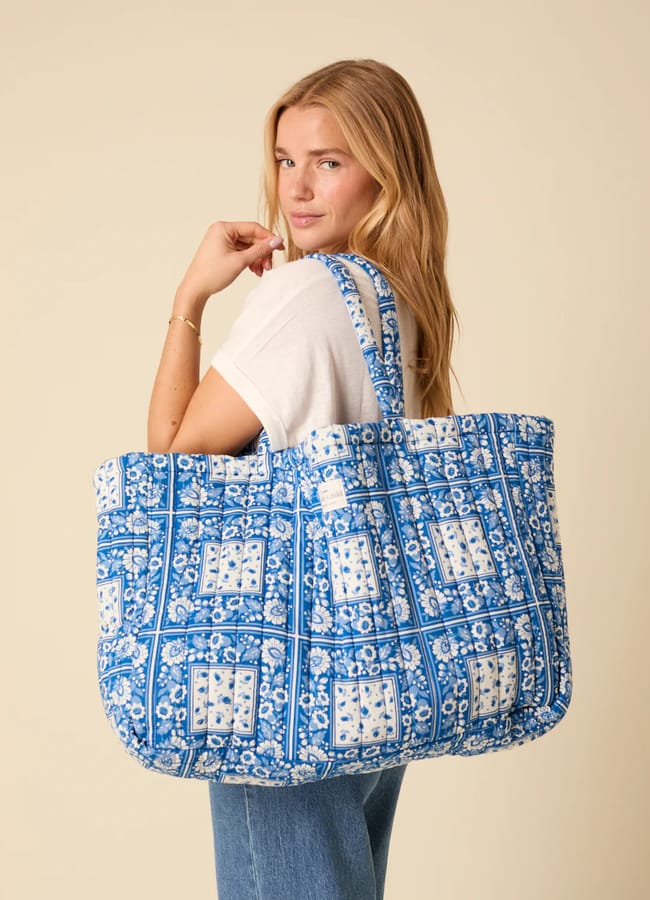 model holding blue Nobody's Child Blue Printed Quilted Tote Bag