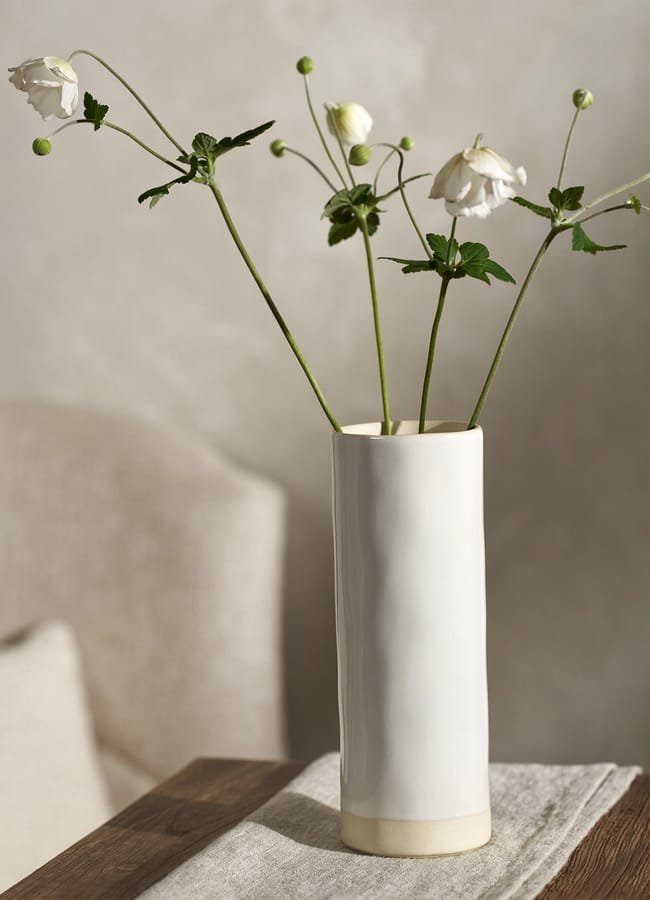 Parham Ceramic Cylinder Vase on side table with flowers