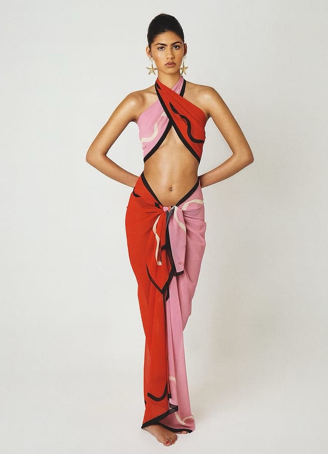 model wearing pink and red sarong set