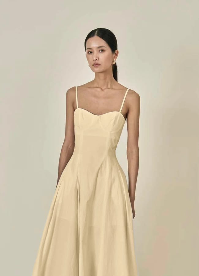 model wearing buttermilk yellow dress