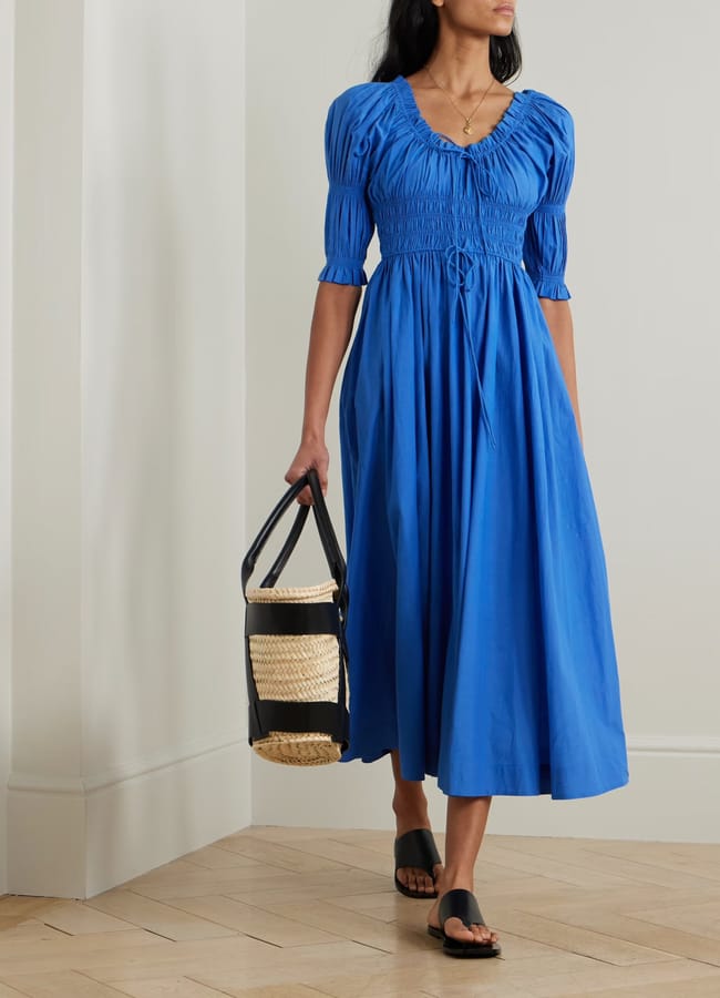 model wearing blue DÔEN Ischia shirred organic cotton-blend voile midi dress