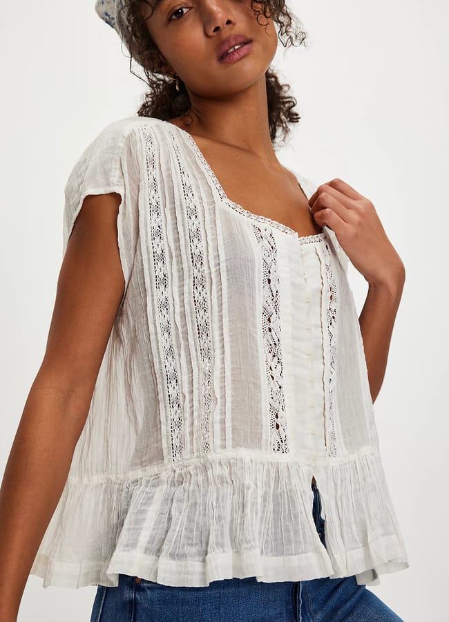 model wearing white lace blouse