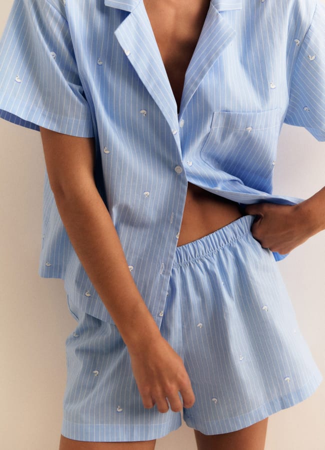 close up of model wearing blue pyjama shorts set