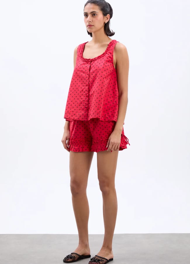 model wearin red mafalda ruffle neck top and shorts
