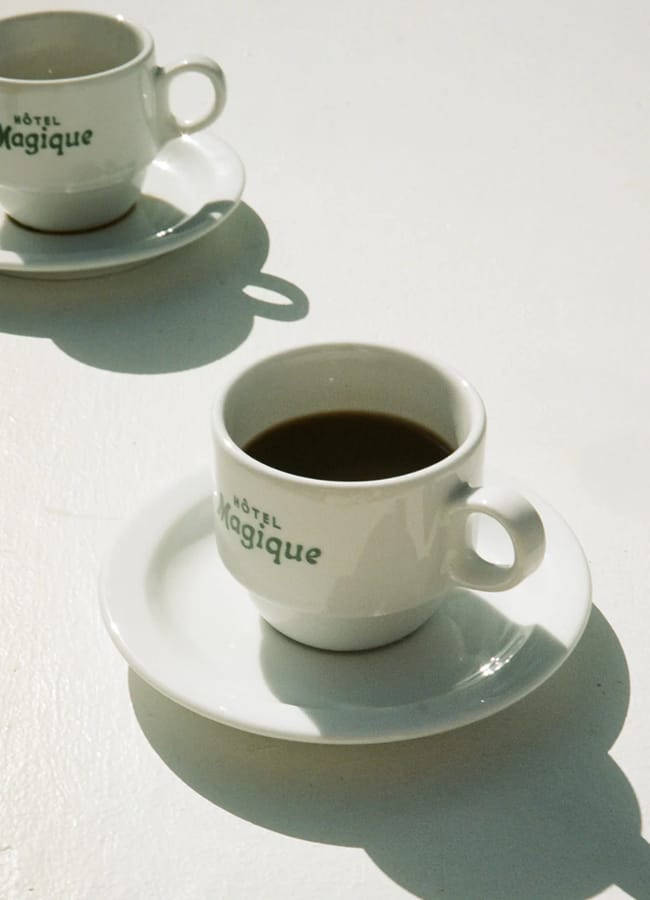 MUH Hotel Magique Cup & Saucer Set x.2 on table